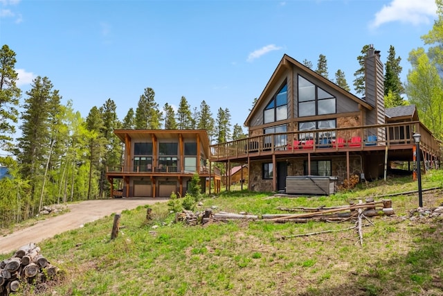 1009 American Way, Breckenridge, CO 80424 - rear view of house with stairs, concrete driveway, stone siding, a deck, and an attached garage