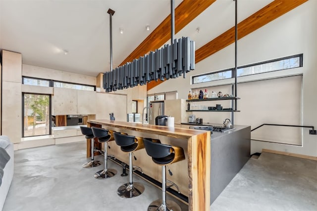 1009 American Way, Breckenridge, CO 80424 - bar area with concrete floors, healthy amount of natural light, a high ceiling, and wall oven