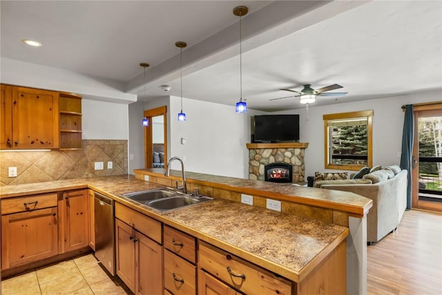 435 Ore House Plz Unit 202, Steamboat Springs, CO 80487 - kitchen with a sink, a peninsula, stainless steel dishwasher, open shelves, and decorative backsplash