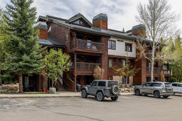 435 Ore House Plz Unit 202, Steamboat Springs, CO 80487 - view of building exterior with stairs and uncovered parking