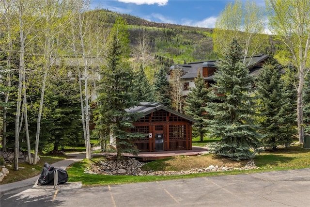 435 Ore House Plz Unit 202, Steamboat Springs, CO 80487 - view of community with a view of trees, a deck with mountain view, and uncovered parking