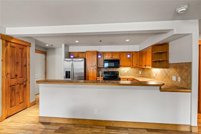 435 Ore House Plz Unit 202, Steamboat Springs, CO 80487 - kitchen featuring black appliances, brown cabinetry, open shelves, a peninsula, and light wood finished floors