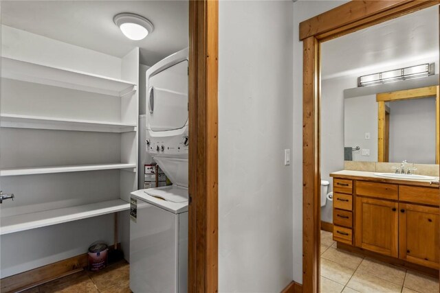 435 Ore House Plz Unit 202, Steamboat Springs, CO 80487 - laundry room featuring stacked washer / drying machine and light tile patterned floors