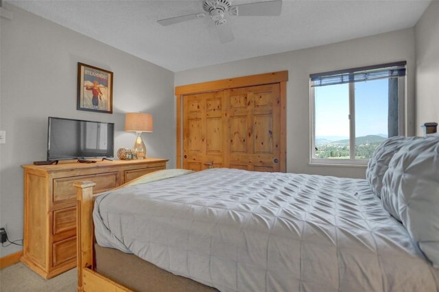 1805 River Queen Ln Unit 201, Steamboat Springs, CO 80487 - bedroom featuring light carpet, a closet, and ceiling fan