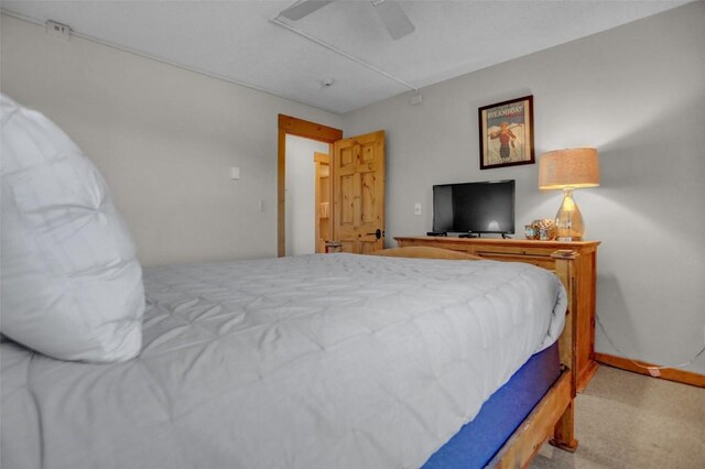1805 River Queen Ln Unit 201, Steamboat Springs, CO 80487 - bedroom with carpet floors, a ceiling fan, and baseboards