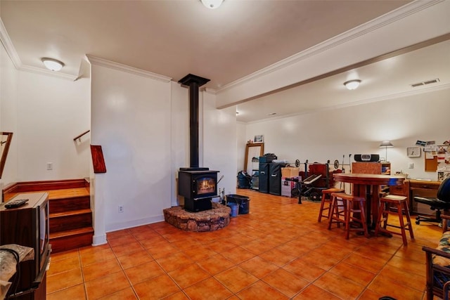 1023 Raven Way, Como, CO 80432 - tiled living room with a wood stove, visible vents, and ornamental molding