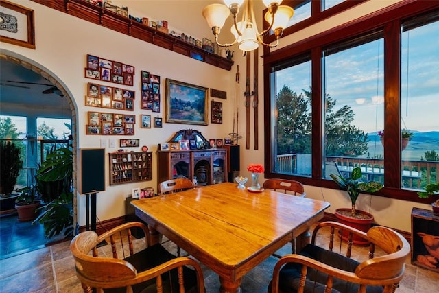 1023 Raven Way, Como, CO 80432 - dining room featuring arched walkways, a wealth of natural light, a notable chandelier, and tile patterned floors