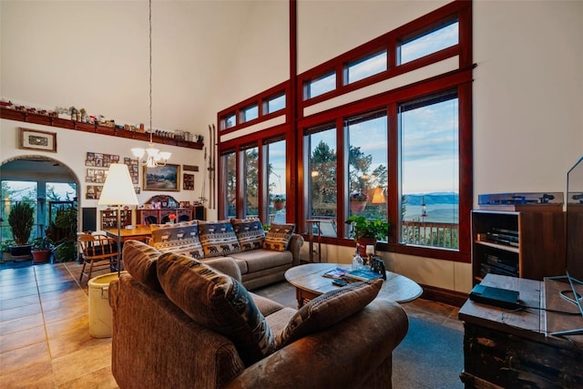1023 Raven Way, Como, CO 80432 - living area featuring arched walkways, a high ceiling, an inviting chandelier, and tile patterned floors