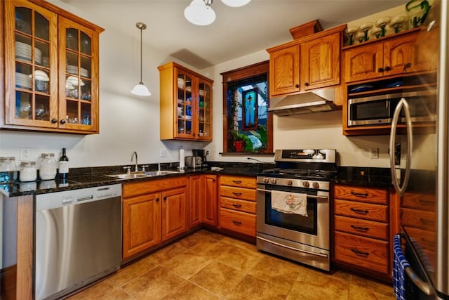 1023 Raven Way, Como, CO 80432 - kitchen with stainless steel appliances, a sink, under cabinet range hood, brown cabinets, and decorative light fixtures
