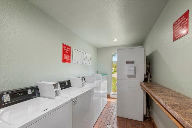 9490 Ryan Gulch Rd Unit 94202, Silverthorne, CO 80498 - community laundry room featuring separate washer and dryer, brick flooring, a textured wall, recessed lighting, and a textured ceiling