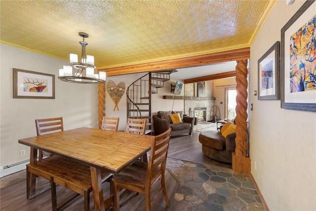 9490 Ryan Gulch Rd Unit 94202, Silverthorne, CO 80498 - dining space featuring stairway, ornamental molding, a chandelier, baseboard heating, and dark wood finished floors