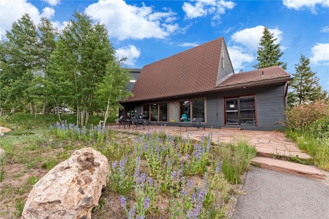 9490 Ryan Gulch Rd Unit 94202, Silverthorne, CO 80498 - rear view of property with a patio area and a metal roof