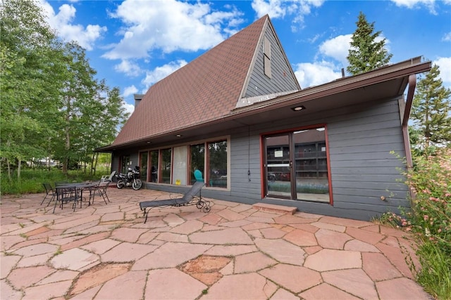 9490 Ryan Gulch Rd Unit 94202, Silverthorne, CO 80498 - back of house featuring a patio area and a chimney