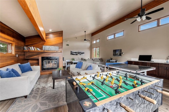 9490 Ryan Gulch Rd Unit 94202, Silverthorne, CO 80498 - recreation room with ceiling fan, wood finished floors, a glass covered fireplace, a high ceiling, and wood walls
