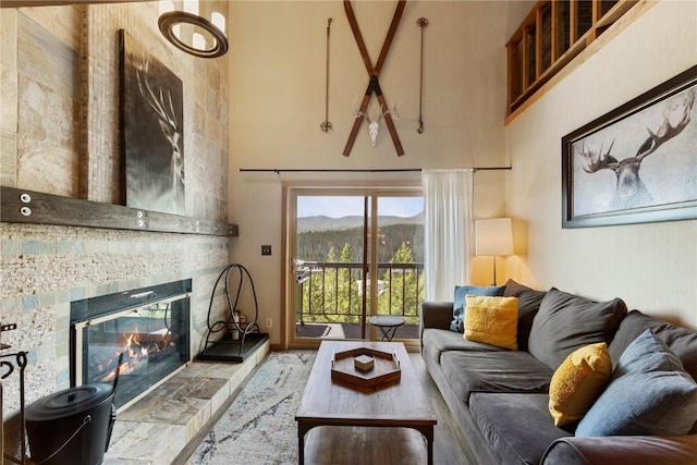 9490 Ryan Gulch Rd Unit 94202, Silverthorne, CO 80498 - living room featuring a towering ceiling, a tile fireplace, and a mountain view