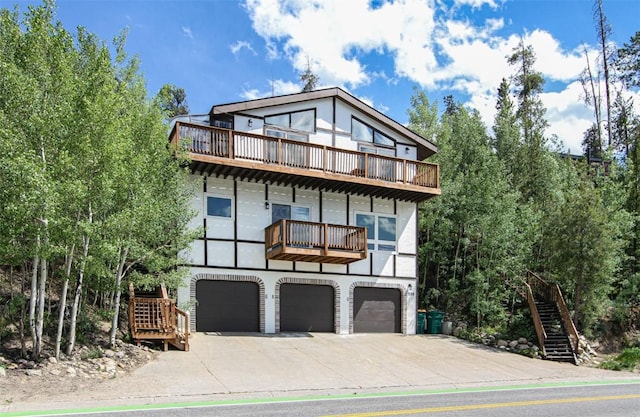 338 Deer Path Rd, Dillon, CO 80435 - view of front of house with a balcony, an attached garage, and driveway