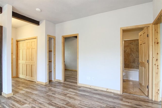 338 Deer Path Rd, Dillon, CO 80435 - unfurnished bedroom featuring wood finished floors, ensuite bathroom, and a closet