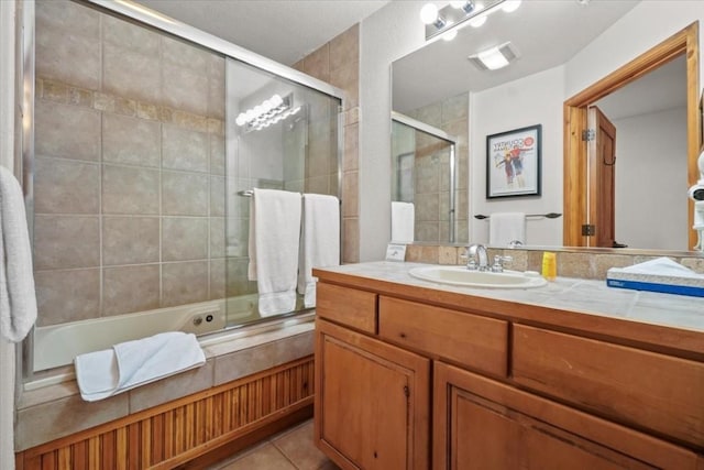 655 Four Oclock Rd Unit 209, Breckenridge, CO 80424 - bathroom featuring tiled shower / bath combo, vanity, and tile patterned floors