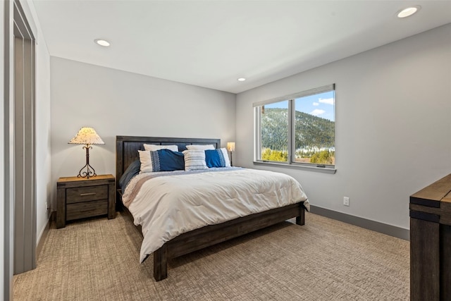 bedroom featuring light carpet, baseboards, and recessed lighting