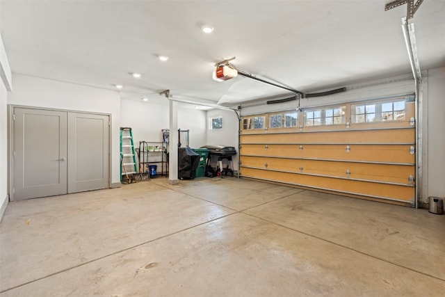 garage featuring recessed lighting and a garage door opener