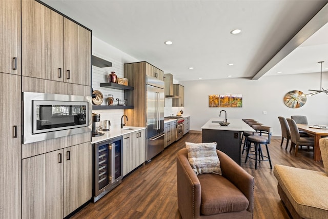 kitchen with open shelves, a sink, built in appliances, modern cabinets, and wine cooler