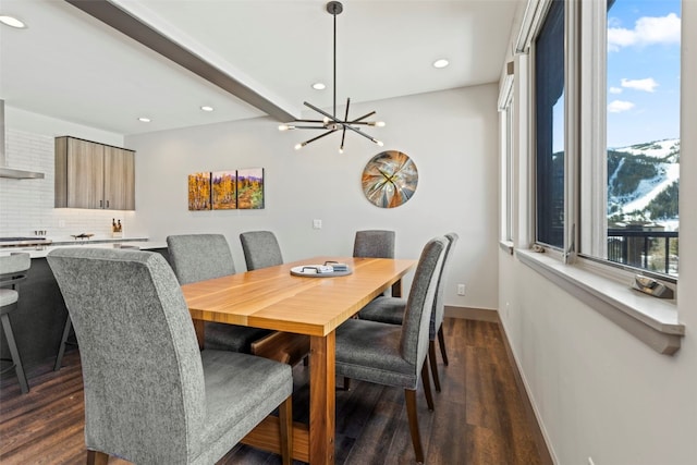 dining space with recessed lighting, dark wood-style flooring, baseboards, and a notable chandelier