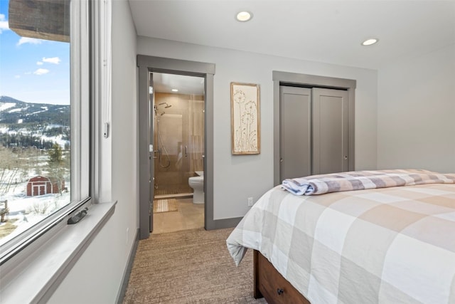 bedroom featuring light carpet, baseboards, recessed lighting, and connected bathroom