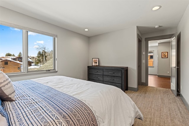 carpeted bedroom featuring recessed lighting and baseboards