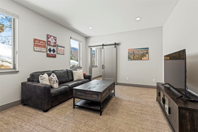 living room with a wealth of natural light, recessed lighting, and a barn door