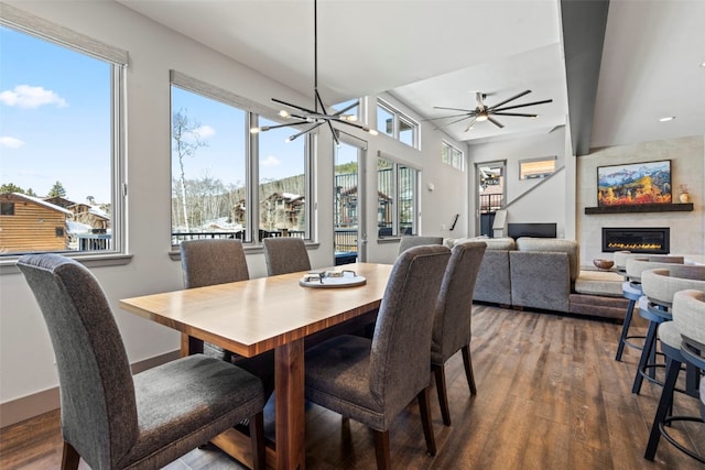 dining area featuring baseboards, recessed lighting, a ceiling fan, wood finished floors, and a fireplace