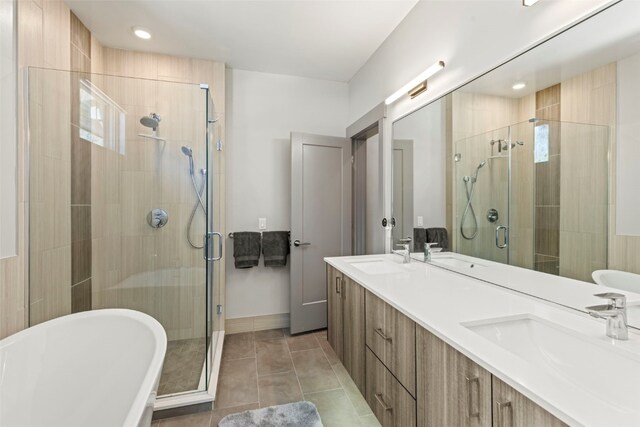 full bath featuring a freestanding tub, a sink, a shower stall, and double vanity