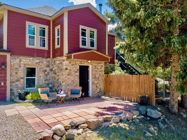 200 N Grant Ave, Oak Creek, CO 80467 - rear view of house featuring stone siding and a patio area