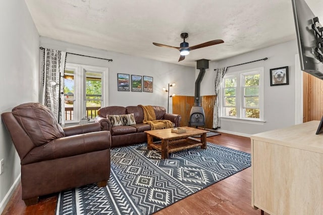200 N Grant Ave, Oak Creek, CO 80467 - living room with dark wood-type flooring, ceiling fan, and a wood stove
