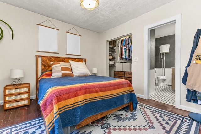 200 N Grant Ave, Oak Creek, CO 80467 - bedroom with wood finished floors, ensuite bathroom, and a textured ceiling