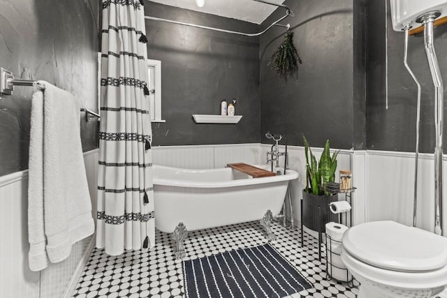 200 N Grant Ave, Oak Creek, CO 80467 - bathroom with a freestanding bath, a wainscoted wall, and curtained shower