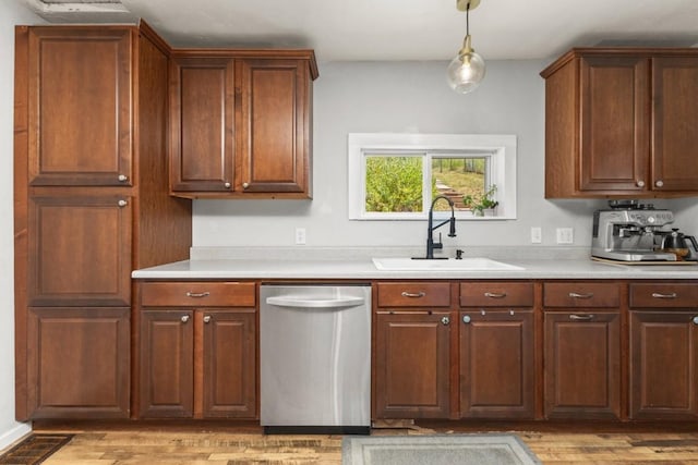 200 N Grant Ave, Oak Creek, CO 80467 - kitchen featuring dishwasher, light countertops, light wood-style flooring, and hanging light fixtures