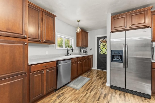 200 N Grant Ave, Oak Creek, CO 80467 - kitchen featuring stainless steel appliances, light wood-type flooring, light countertops, and pendant lighting