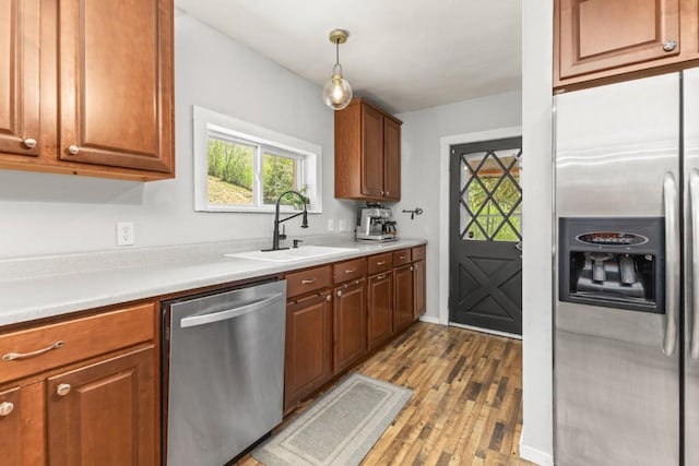 200 N Grant Ave, Oak Creek, CO 80467 - kitchen with appliances with stainless steel finishes, light wood-style flooring, brown cabinets, and light countertops