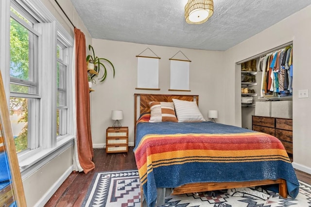 200 N Grant Ave, Oak Creek, CO 80467 - bedroom featuring a textured ceiling, multiple windows, and hardwood / wood-style floors