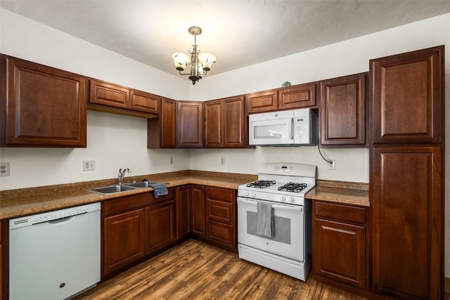 57640 County Road 129, Clark, CO 80428 - kitchen with white appliances, a chandelier, dark wood-style flooring, and decorative light fixtures