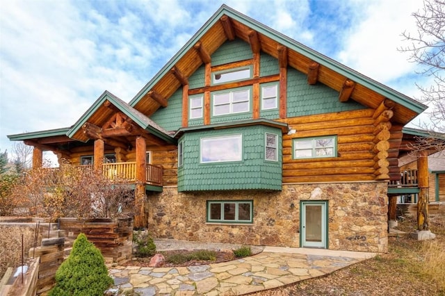 57640 County Road 129, Clark, CO 80428 - rear view of property featuring stone siding, log siding, and a patio