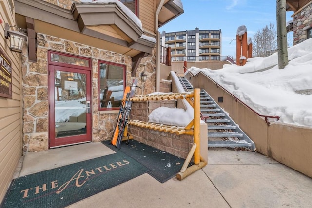 view of snow covered property entrance