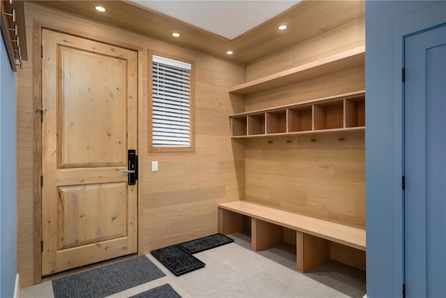 mudroom with wood walls