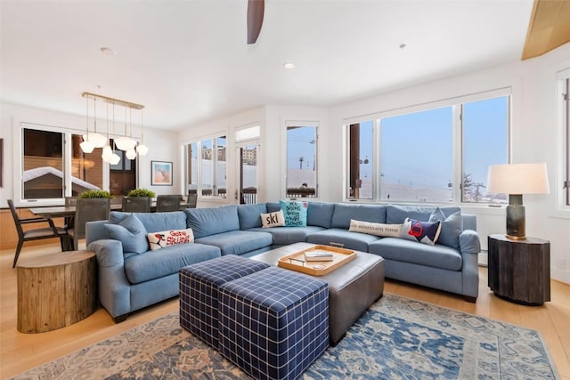 living room featuring hardwood / wood-style floors and ceiling fan