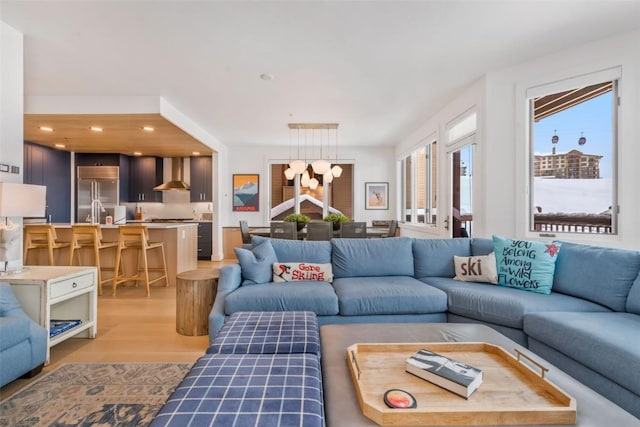 living room featuring an inviting chandelier and light wood-type flooring