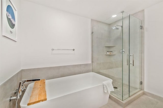 bathroom featuring shower with separate bathtub