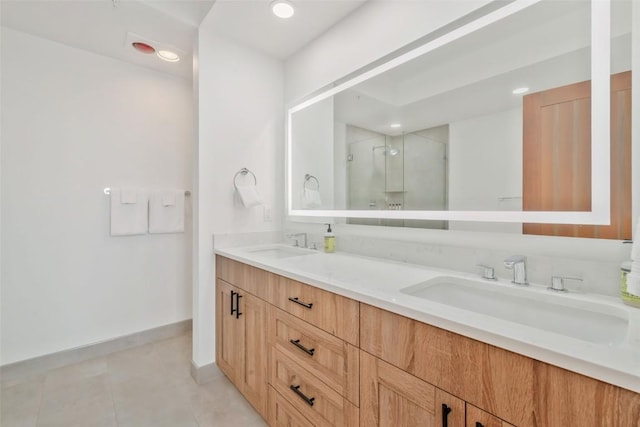 bathroom with tile patterned flooring, vanity, and a shower with door