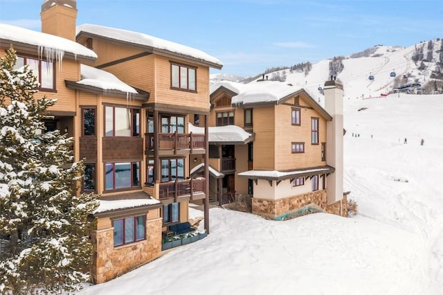 snow covered property with a mountain view