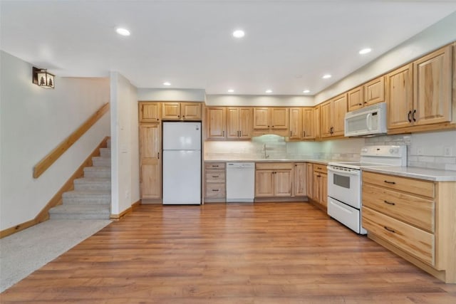 23015 Schussmark Trl Unit C, Oak Creek, CO 80467 - kitchen featuring white appliances, light brown cabinetry, light countertops, tasteful backsplash, and light wood-style floors