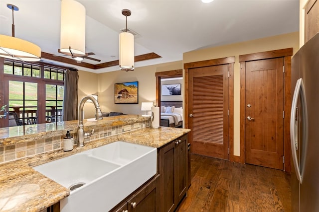 1521 Ski Hill Rd Unit 8313, Breckenridge, CO 80424 - kitchen featuring dark wood-style floors, freestanding refrigerator, decorative light fixtures, light stone countertops, and dark brown cabinetry
